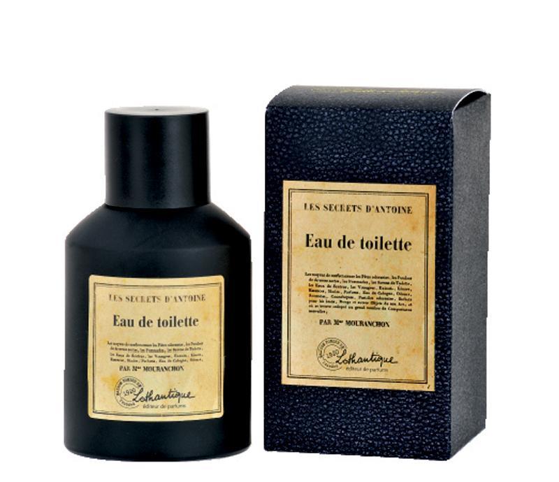 A bottle of Lothantique L'Secrets d' Antoine eau de toilette next to its packaging box, both featuring elegant vintage-style labels and embodying a woodsy spiced citrus fragrance.