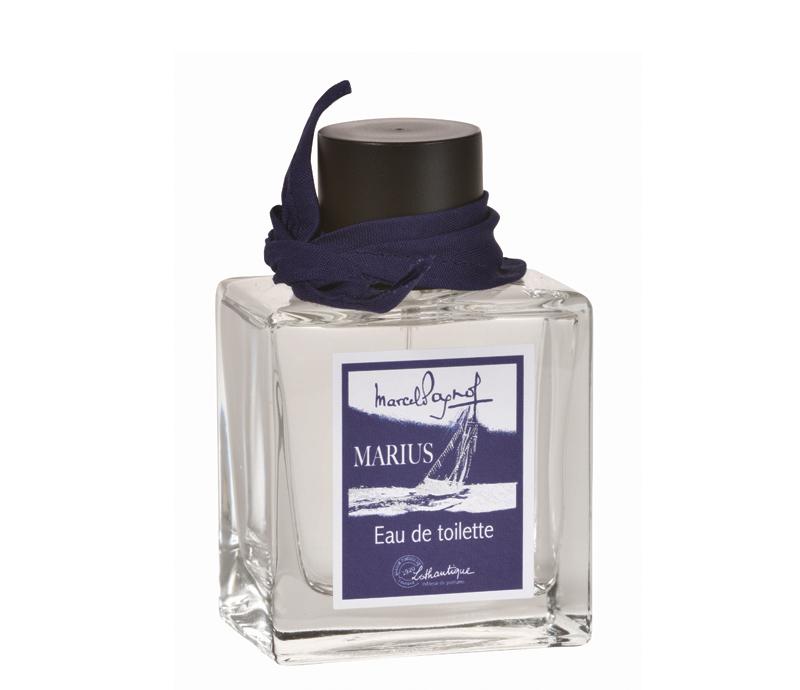 A bottle of Lothantique Marcel Pagnol Marius eau de toilette, featuring a square glass design with a navy blue ribbon around the neck and a label depicting a boat on water.
