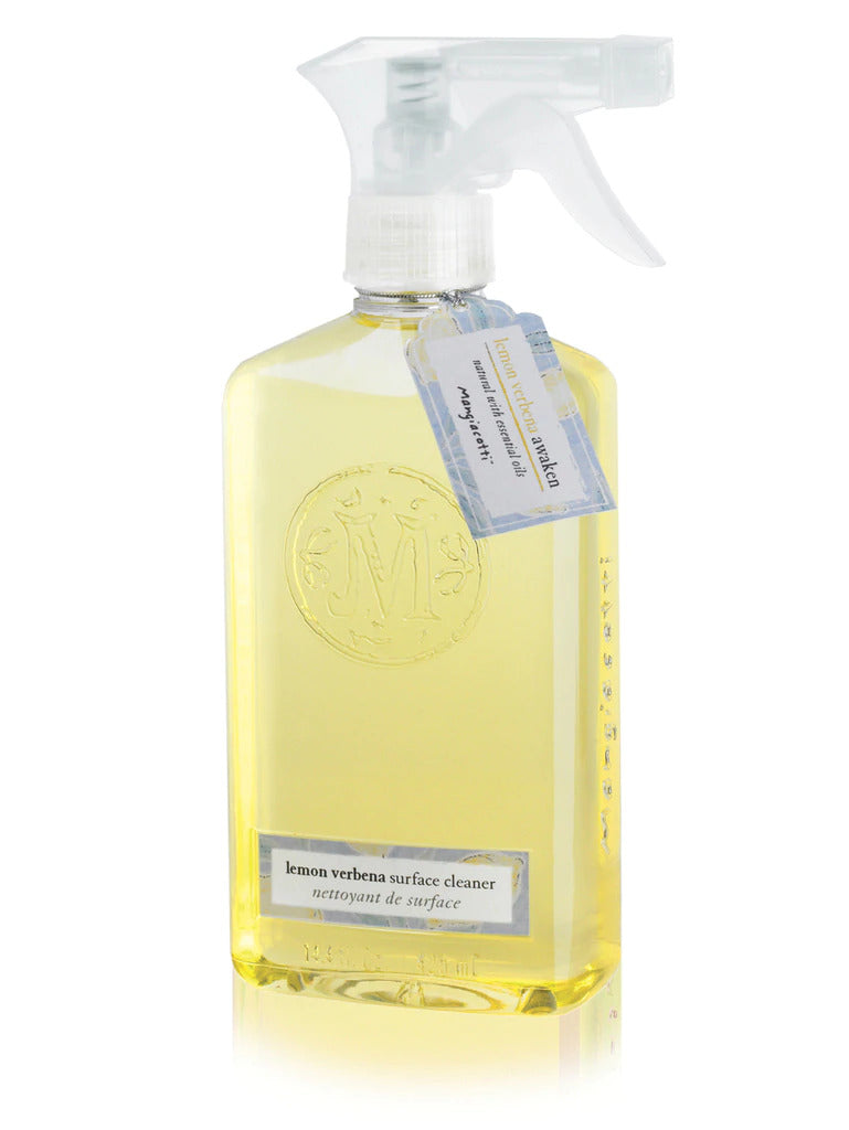 A transparent spray bottle containing yellow Mangiacotti Lemon Verbena Natural Surface Cleaner for non-porous surfaces, labeled in both English and French, with an elegant script logo at the top.