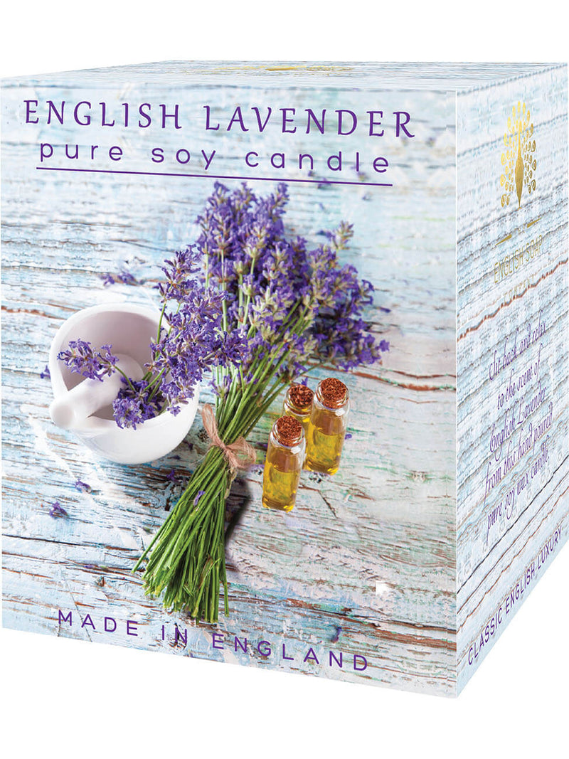 A boxed The English Soap Co. English Lavender soy wax candle with images of fresh lavender stems, essential oil bottles, and a ceramic bowl filled with lavender. The text emphasizes it is made in England and highlights the extended burn.