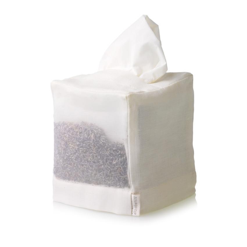 A white elizabeth W Lavender Square Tissue Cover - Ivory with the top tissue partially pulled out, isolated on a white background. The box has a sheer silk side showing dried lavender flowers inside.