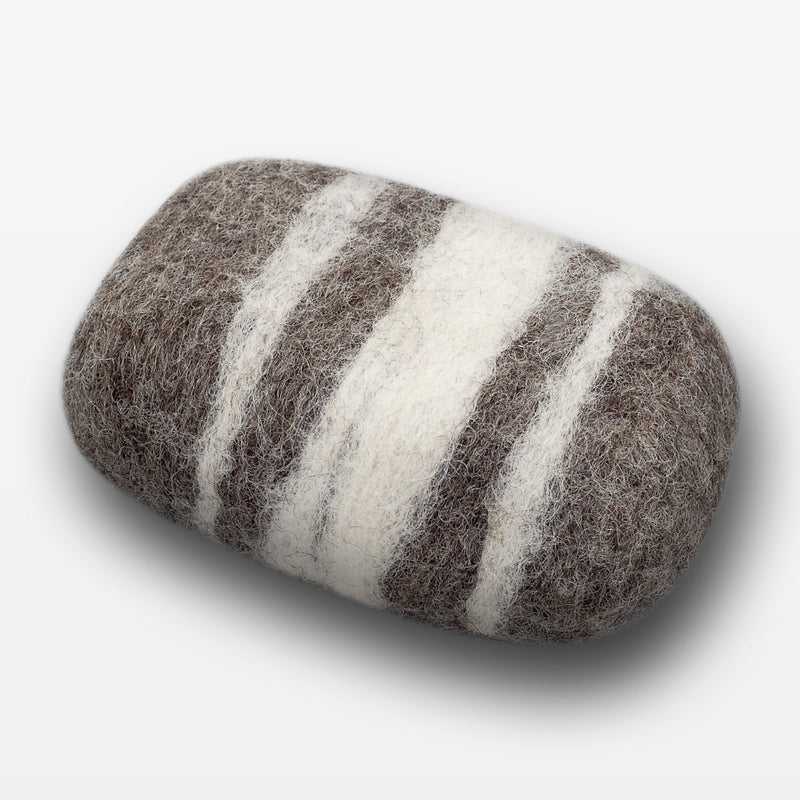 A handmade Fiat Luxe - Striped Lavender felted wool soap bar with natural brown and white stripes, isolated on a white background.