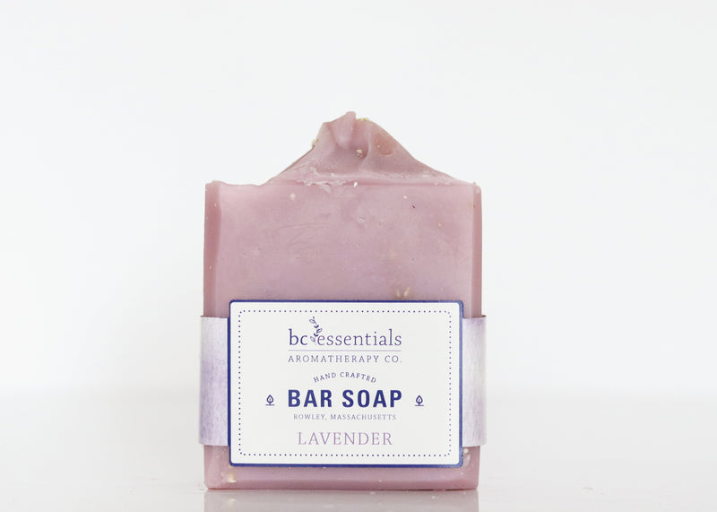 A handmade Lavender Bar Soap from BC Essentials, featuring an organic coconut oil and vegetable base, displayed against a white background with a label detailing product information.