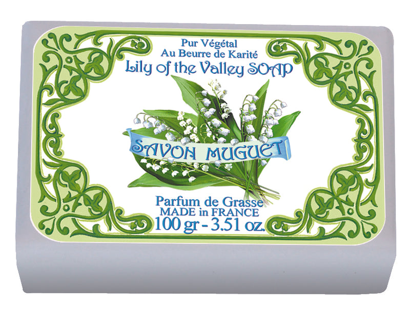A bar of Le Blanc Lily of the Valley Wrapped Soap displayed in its packaging with intricate green designs and text stating "au beurre de karité, savon muguet, handcrafted in France" by Le Blanc Made in France.
