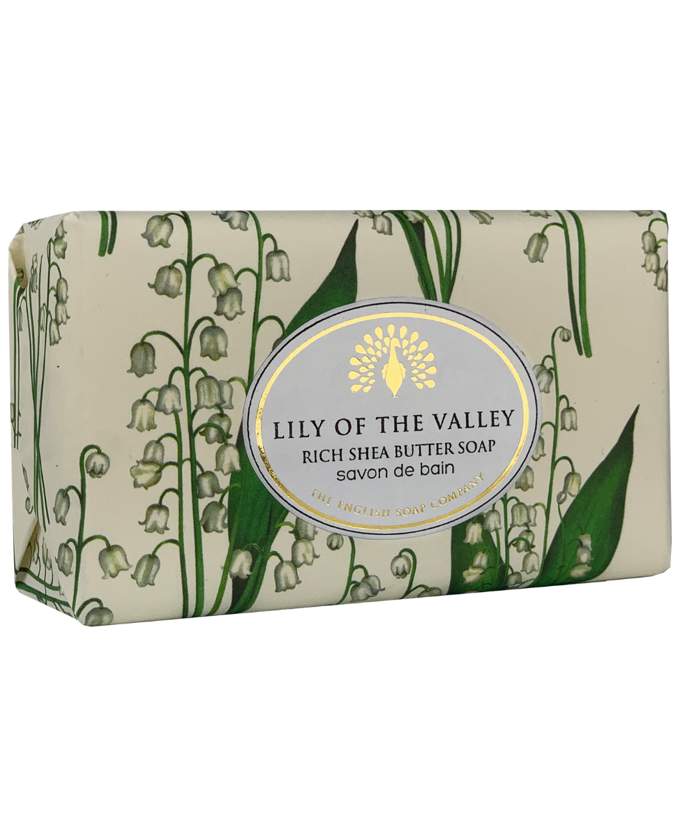 A rectangular bar of The English Soap Co. Lily of The Valley Vintage Italian Wrapped Soap in floral packaging, featuring delicate green and white motifs and a central blue label.