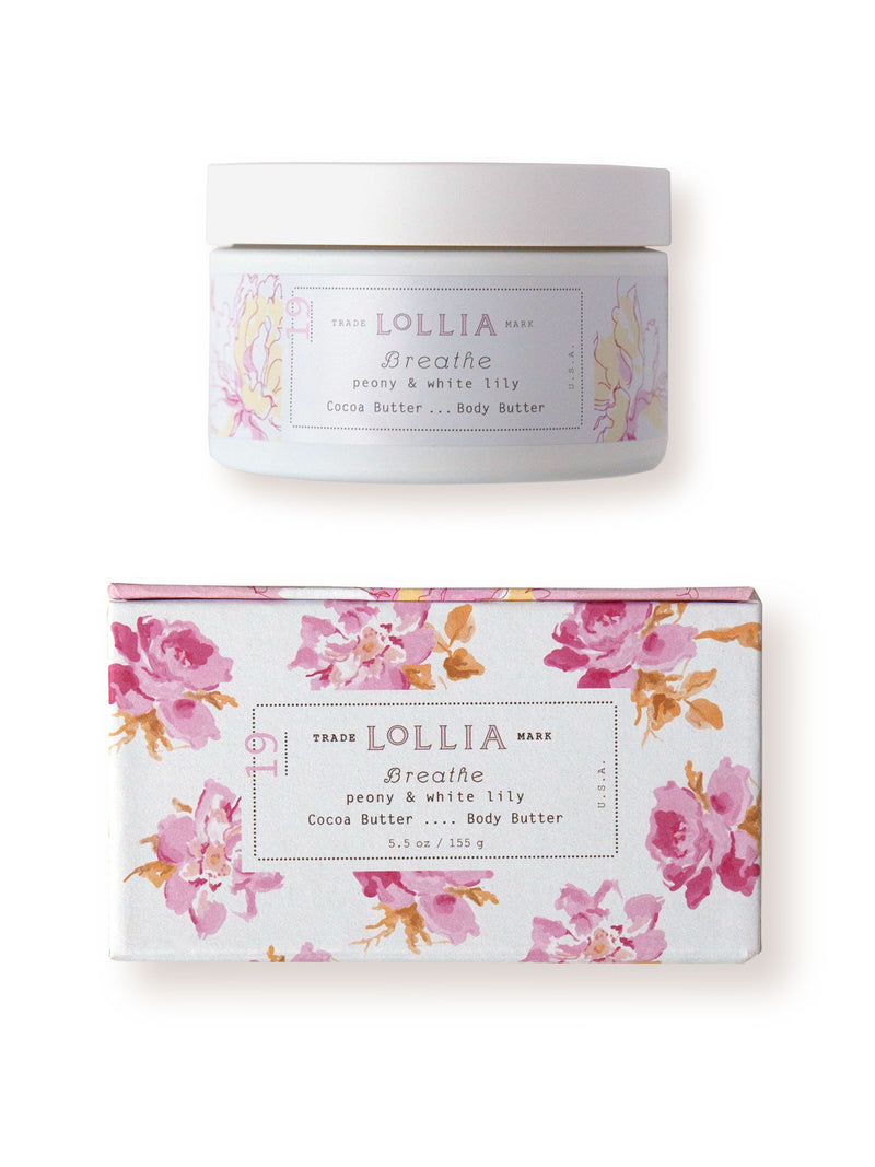 A container and box of Margot Elena's Lollia Breathe Body Butter on a white background. The packaging is adorned with pink and white floral designs with elegant text describing the body butter.