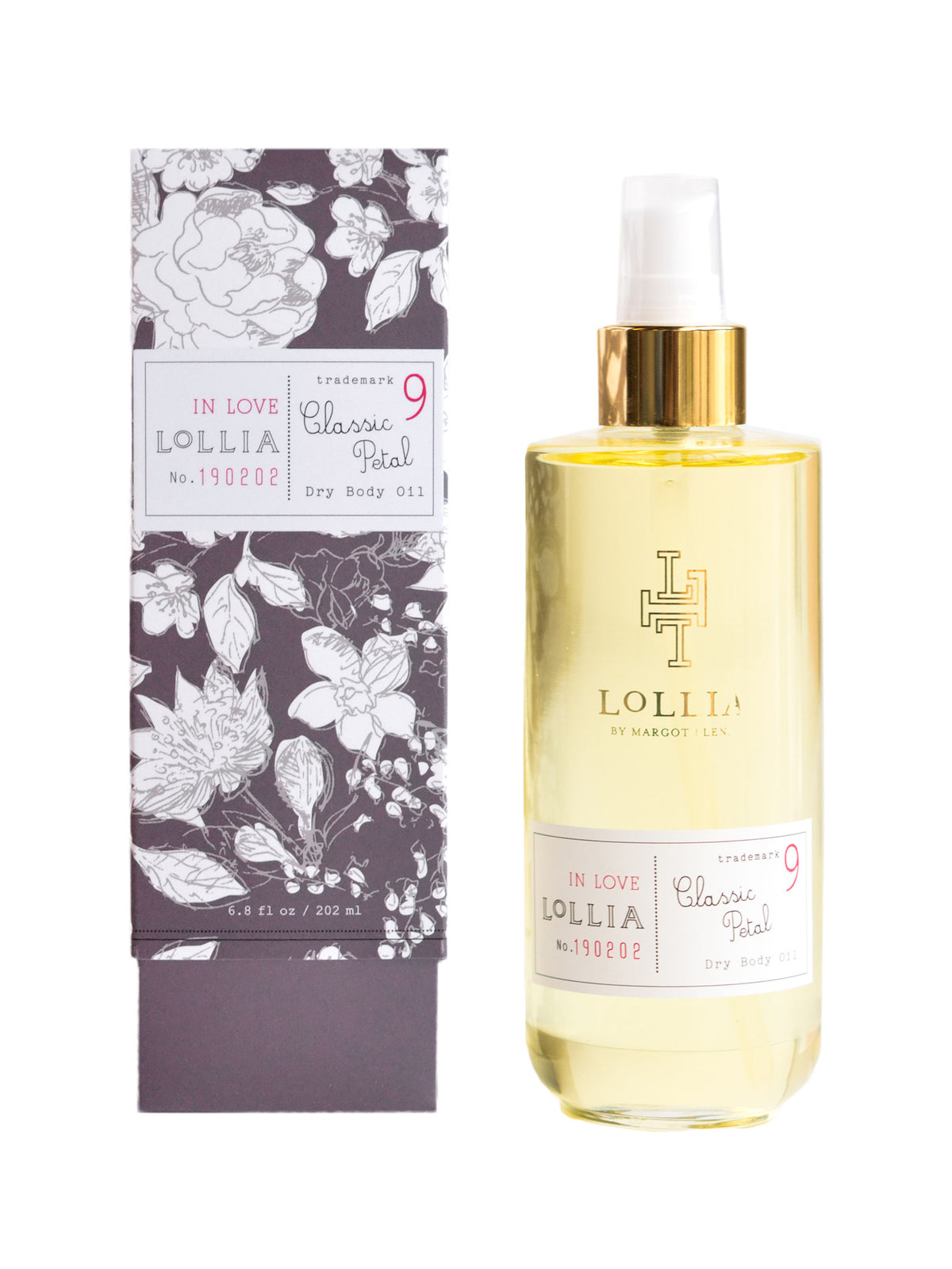 A bottle of Margot Elena Lollia In Love Dry Oil Body next to its floral-patterned packaging box on a white background.