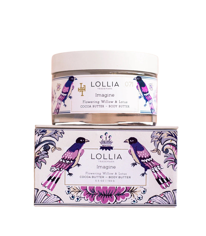 A Margot Elena brand Lollia Imagine Body Butter container and packaging labeled "imagine flowering willow & lotus" with a decorative design featuring pink birds and floral elements, enriched with shea butter.