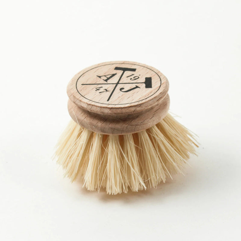 A wooden Andrée Jardin Tradition Handled Dish Brush with stiff, natural bristles. The top of the handle is engraved with a logo featuring a stylized vegetable and the word "veg." The background is plain white.