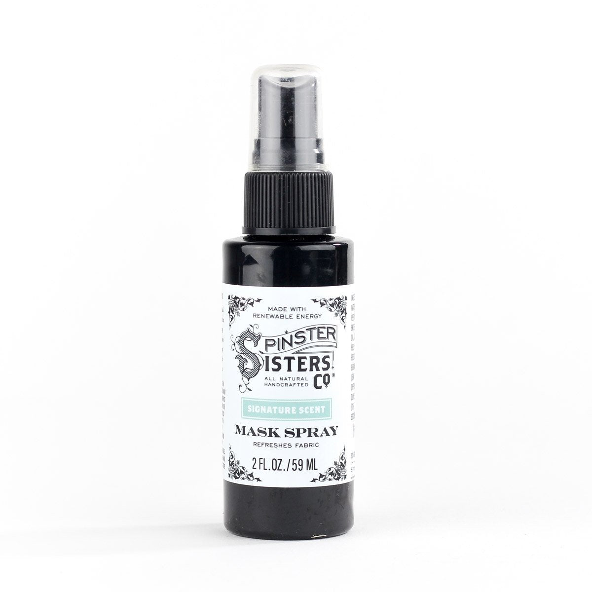 A black and white bottle of Spinster Sisters Mask Spray with a detailed label, against a plain white background.