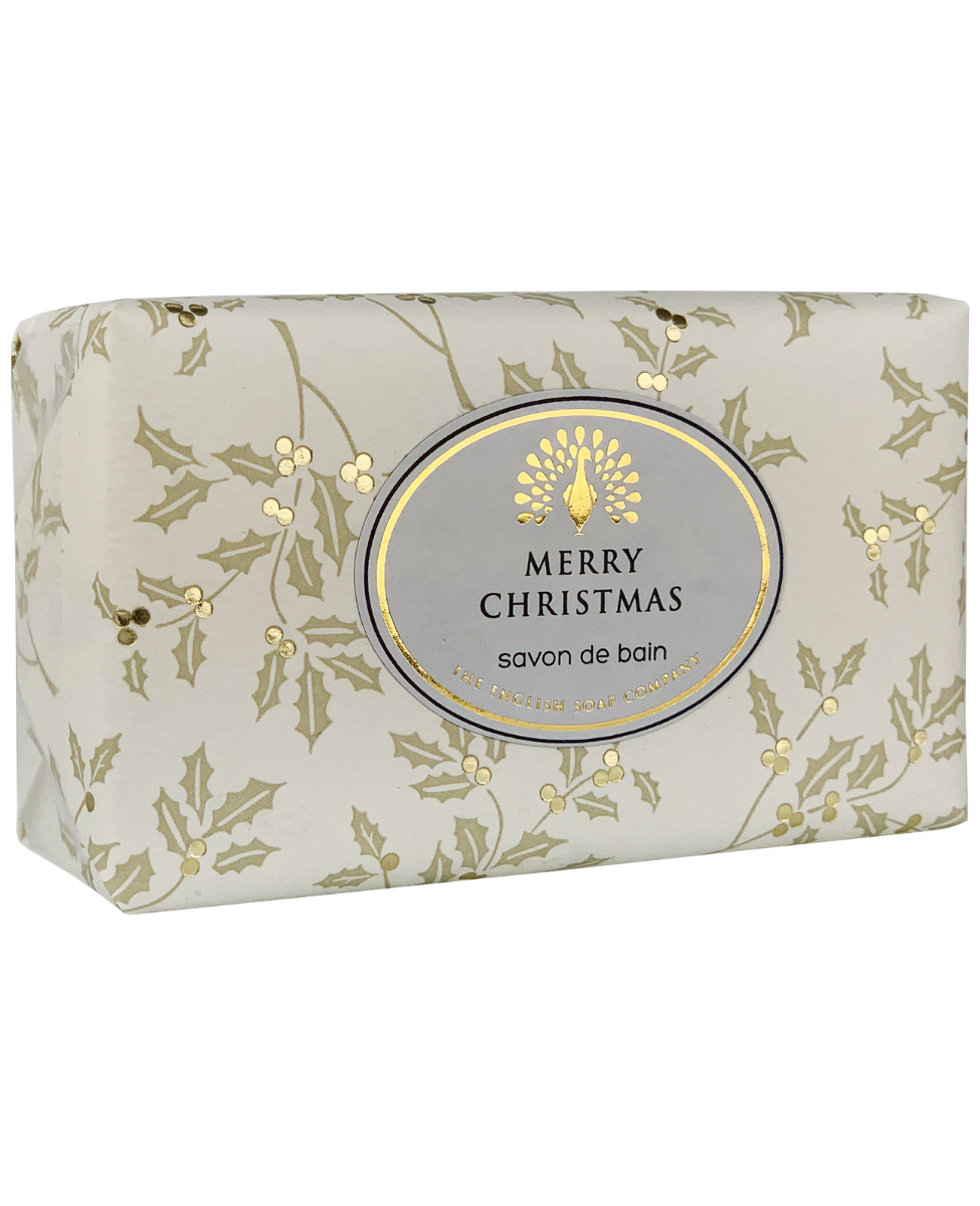 A festive fragrance soap bar wrapped in light beige packaging featuring a delicate pattern of green leaves and golden berries, with a central oval label that reads "The English Soap Co. Merry Christmas Festive Italian Wrapped Soap" from The English Soap Co.