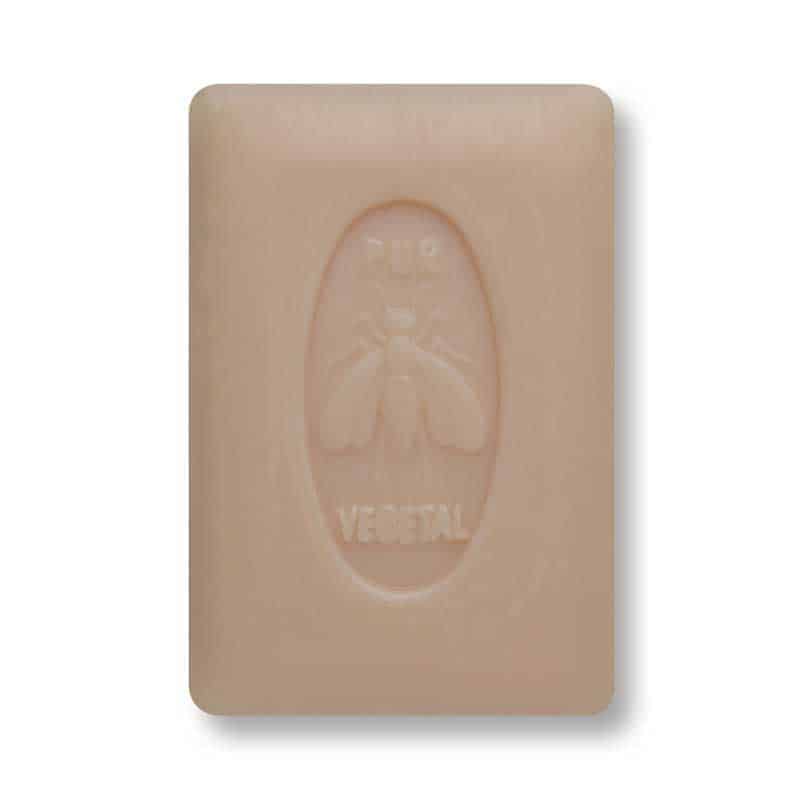 A beige bar of La Lavande - Extra Fragrant Honey - 150 gm vegetable-based soap with embossed branding that includes a logo depicting a bee inside an oval. The background is a uniform light grey.