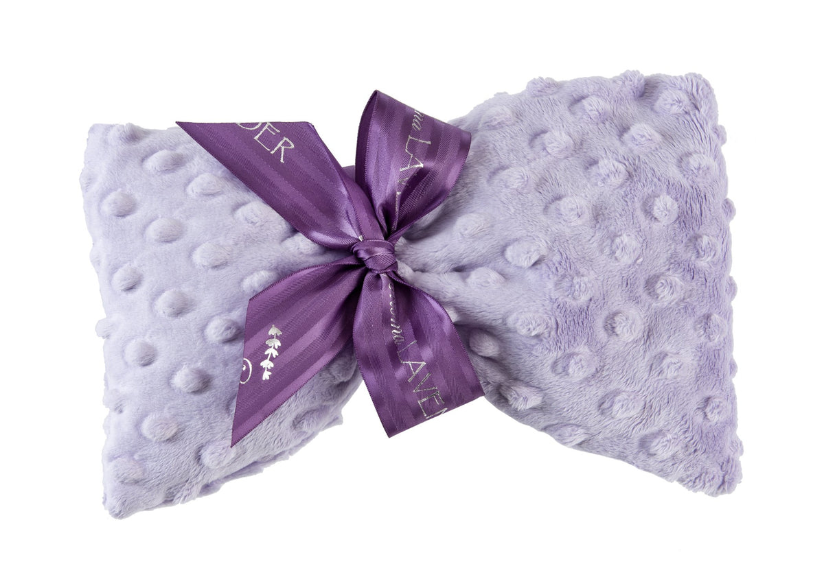 A soft, light purple faux fur pillow styled in a butterfly shape with a darker purple satin ribbon tied in a bow at the center, perfect for Sonoma Lavender - Lavender Dot Spa Mask relaxation and heat therapy.