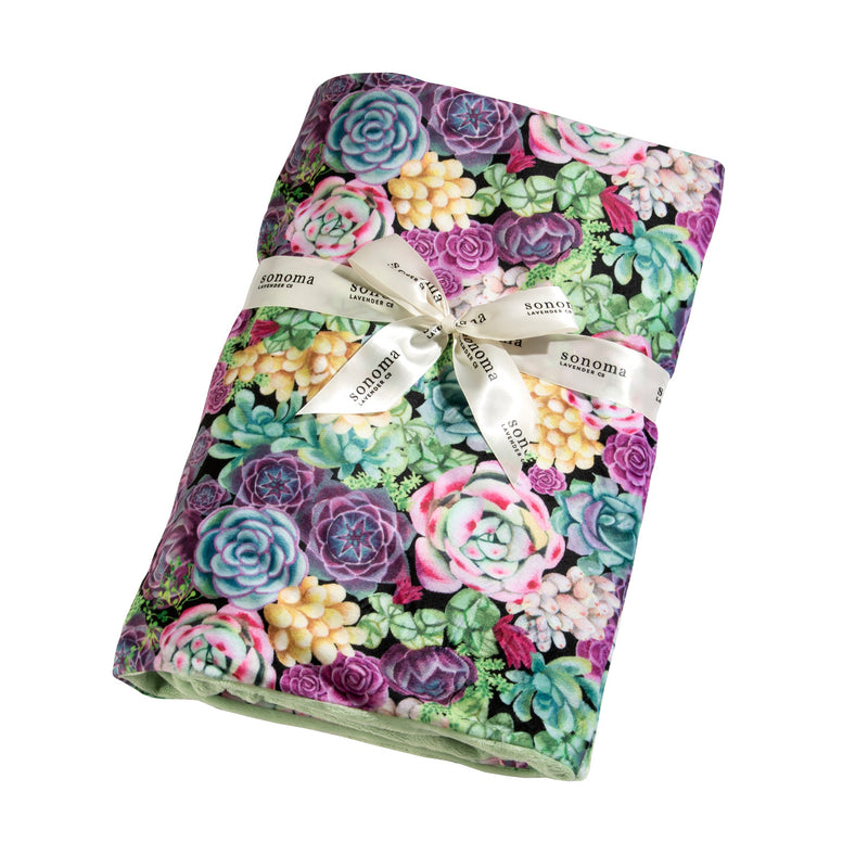 A Sonoma Lavender Succulents Spa Blankie, featuring vibrant pastel colors with a design of assorted succulents, tied neatly with a decorative ribbon labeled "Sonoma." This spa blanket is an ideal addition to.