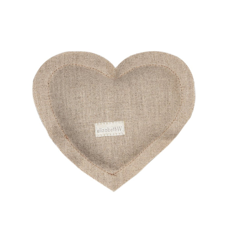 A elizabeth W Linen Heart Sachet - Natural with a rustic texture, featuring a small tag in the center with the text "elizabeth W." The background is plain and light-colored.