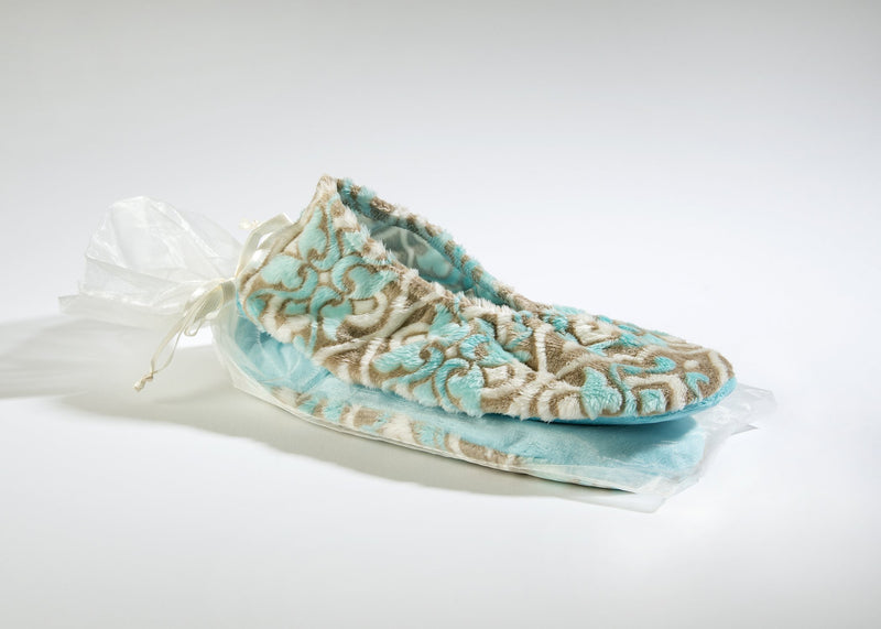 A Sonoma Lavender Sonoma OceanAire Le Mer Heated Footies slipper with embossed floral patterns, tied with a white ribbon, displayed on a plain white background features microwaveable foot warmers for added comfort.