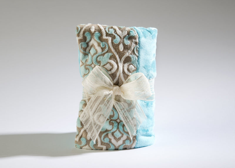 Two Sonoma Lavender Sonoma OceanAire Le Mer Heat Wraps with a paisley pattern in neutral tones and soft blue, tied together with a large white ribbon bow, on a plain background. Ideal for use as a heat wrap at OceanAire.