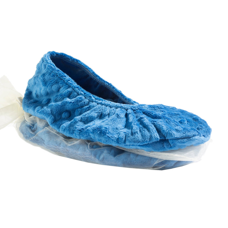 A Sonoma Lavender OceanAire Ocean Blue Dot Heated Footies slipper with a flaxseed insert and a rubber sole, partially covered by a transparent plastic bag, isolated on a white background.