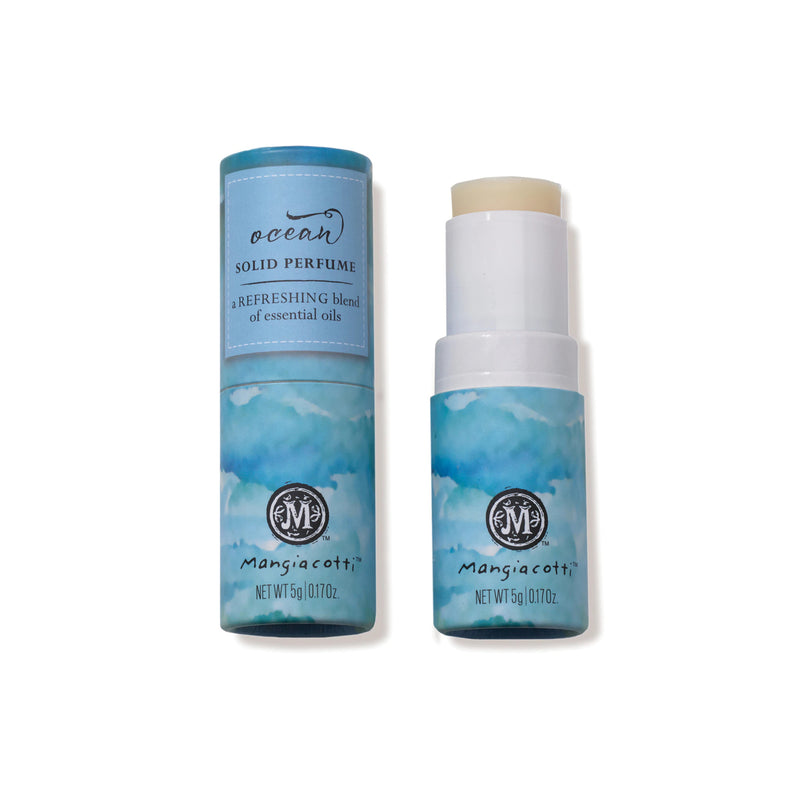 Two cylindrical containers of Mangiacotti Ocean Solid Perfume, each featuring a blue and white watercolor design and infused with essential oils, with one container opened to show the product.