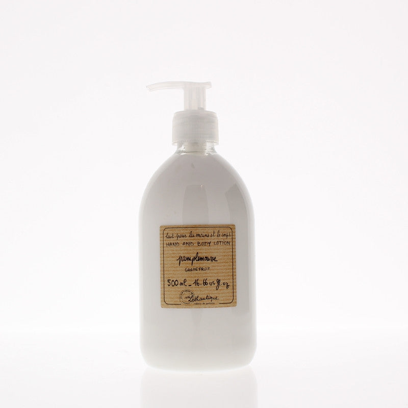 A clear plastic pump bottle of Lothantique Pamplemousse Grapefruit Body Lotion 500ml with a vintage-style label, isolated on a white background. The bottle contains 500ml of the product.