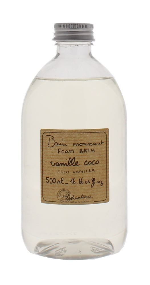 A clear plastic bottle filled with a light yellow liquid, labeled as 'Lothantique Vanilla Coconut Foam Bath,' holds 500 ml of the product. The vintage-style label is centered on the bottle.