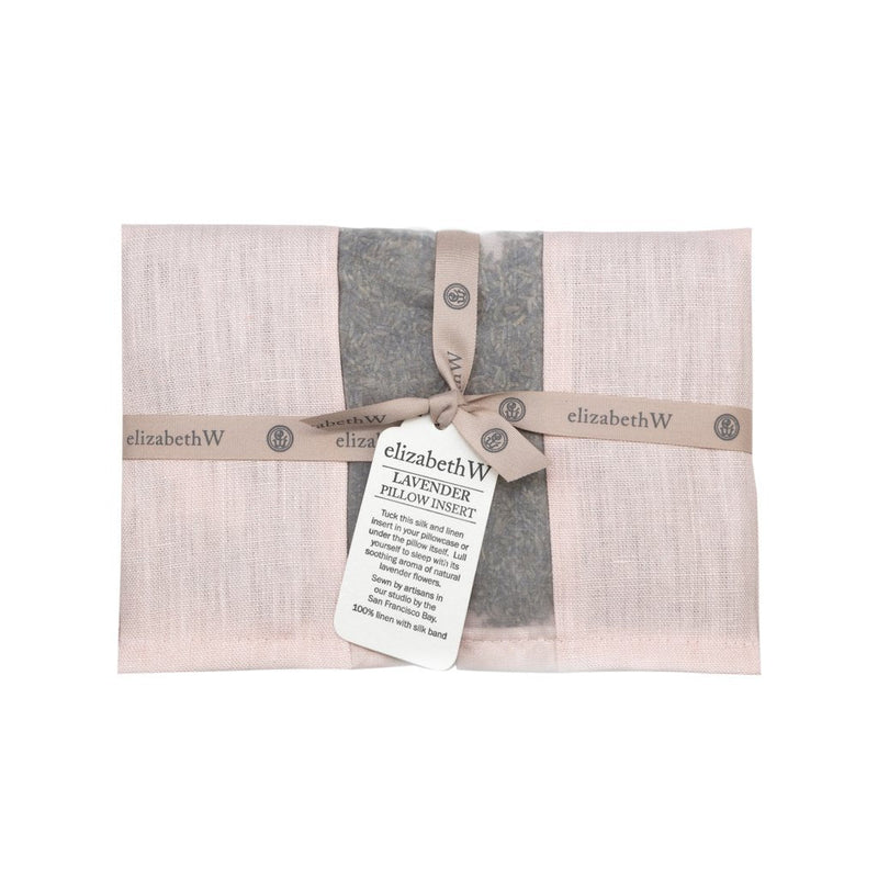 A elizabeth W Lavender Pillow Insert - Pink, filled with French lavender and wrapped in mauve cloth with a ribbon and tag detailing the product information, on a neutral background.