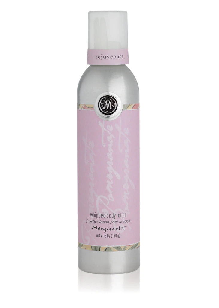 A bottle of "Mangiacotti Pomegranate Whipped Body Lotion" with pomegranate and shea butter, featuring a soft pink label and a gray cap, isolated on a white background. The label includes "Mangiacotti.