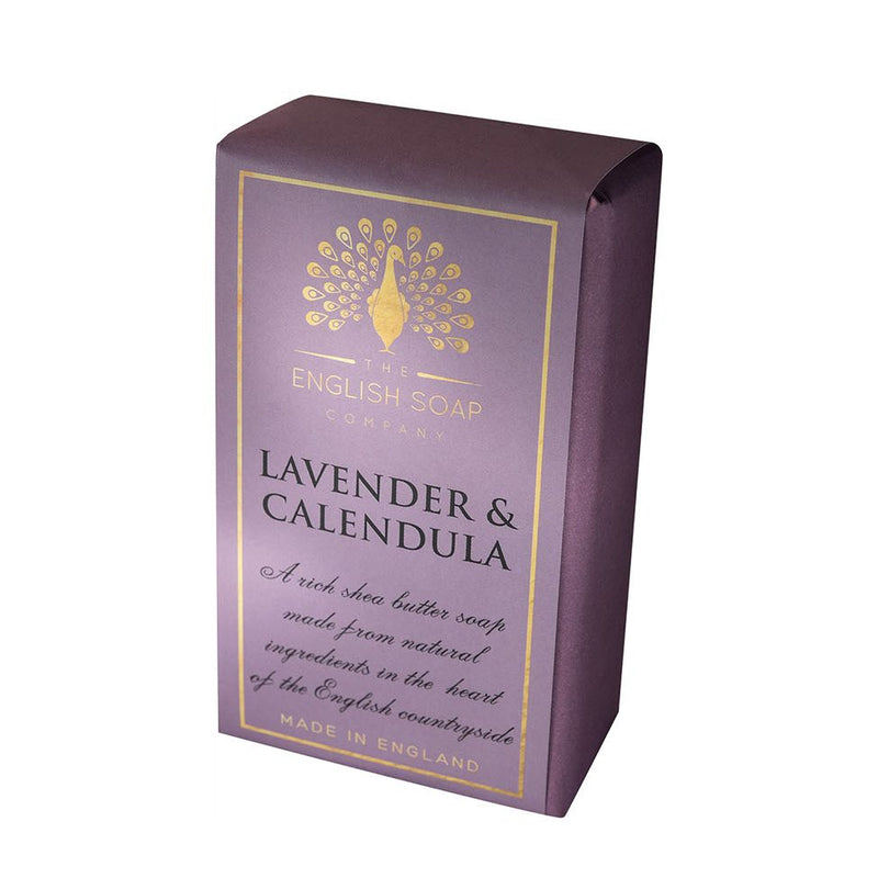 A purple and gold cruelty-free soap box from The English Soap Co., labeled "Pure Indulgence Lavender & Calendula" with a decorative peacock motif, stating it's made from natural ingredients in England.