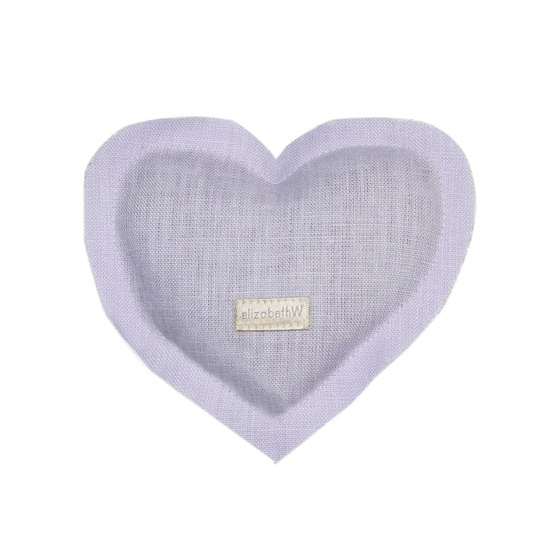 A heart-shaped lavender sachet in pale purple, crafted from 100% Linen, with a woven tag displaying the text "elizabeth W" on a white background.