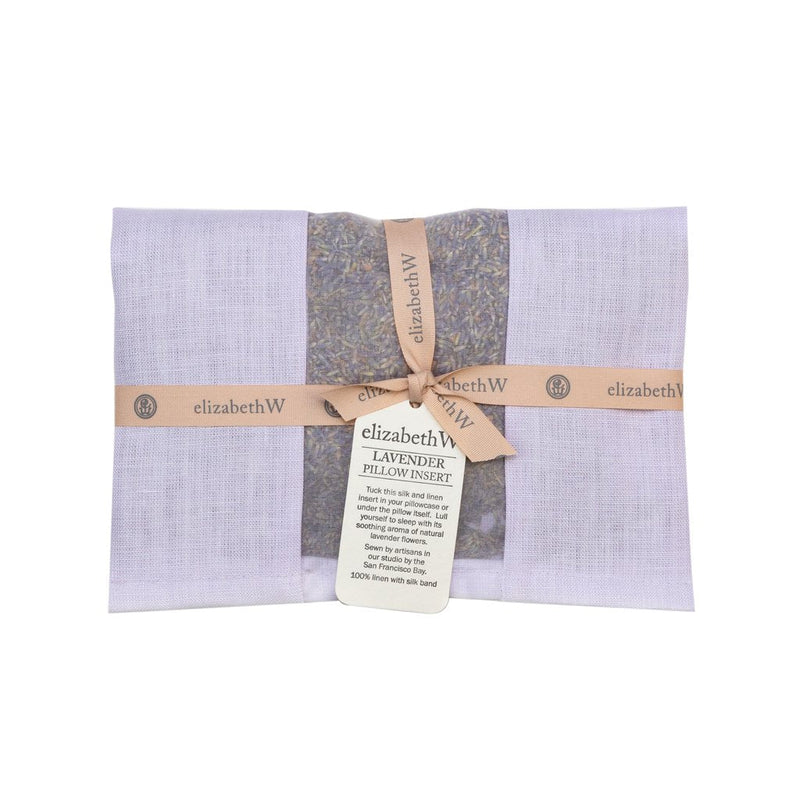 elizabeth W Lavender Pillow Insert - Purple gift wrapped in light beige fabric, tied with a beige ribbon and a descriptive tag from “elizabeth W.” The beige box also displays visible French lavender flowers through a transparent segment