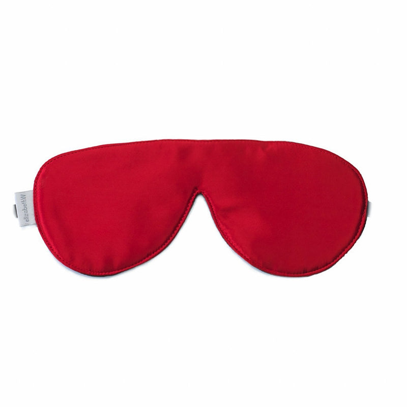 A elizabeth W Silk Sleep Mask in red isolated on a white background. The mask features a smooth, contoured design and is positioned horizontally with the tag visible on the left side.