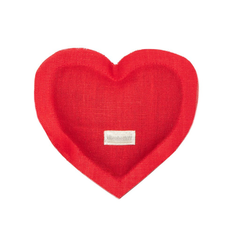 A red elizabeth W Linen Heart Sachet with a white label stitched in the center featuring the text "#iloveyou321." The background is plain white, infused with herbal aroma.