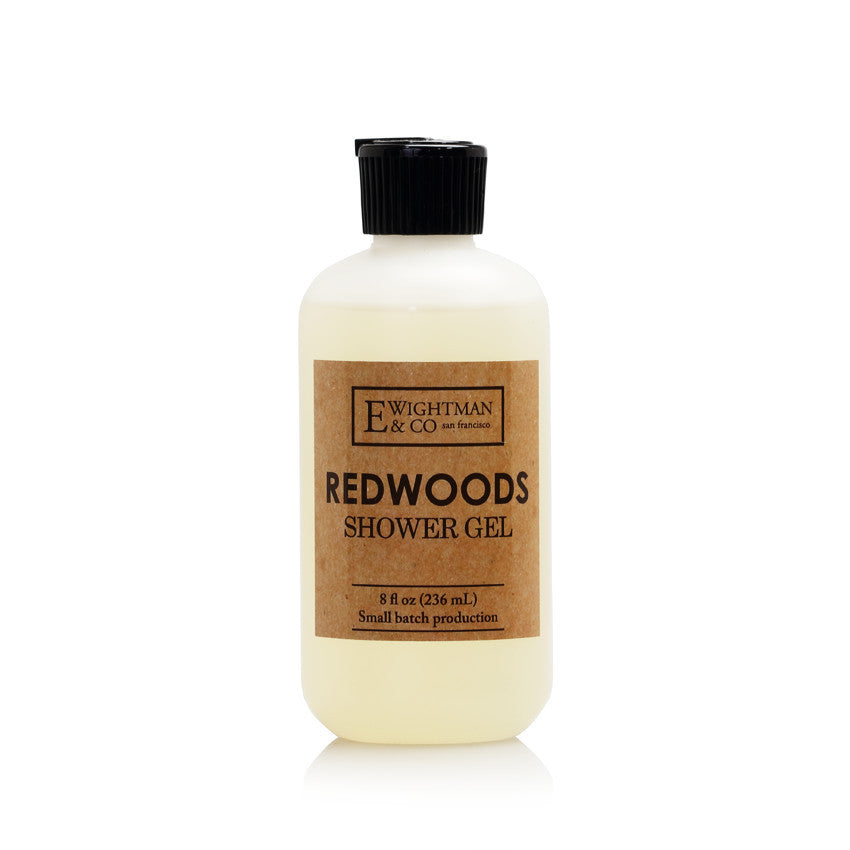 A bottle of "elizabeth W Redwoods Shower Gel" by elizabeth W, featuring a simplistic label design on a translucent bottle with a black cap, isolated on a white background, infused with.