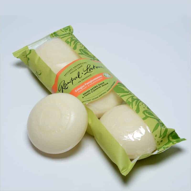 A package of La Lavande Cologne Soap, with two white, spongy balls placed outside the packaging, against a white background.