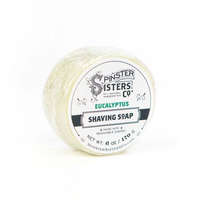 A jar of Spinster Sisters Co. Eucalyptus Shaving Soap with a white and dark blue label, displayed on a plain white background.