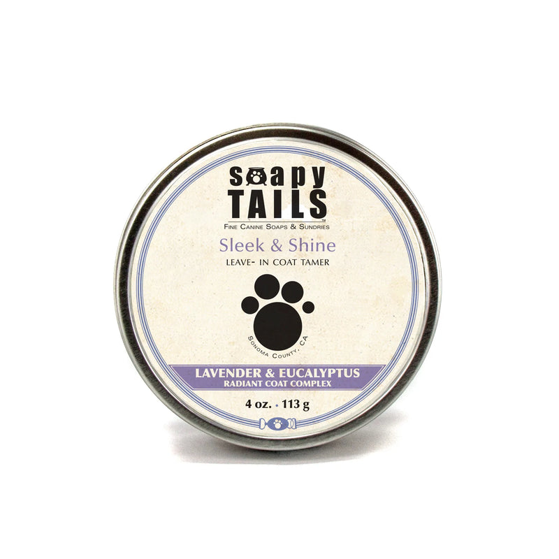 A circular canister of Three Sisters Aphothecary's "Soapy Tails Lavender & Eucalyptus Sleek & Smooth Coat Tamer," labeled for lavender & eucalyptus scent, enhanced with shea butter, with a paw print design.