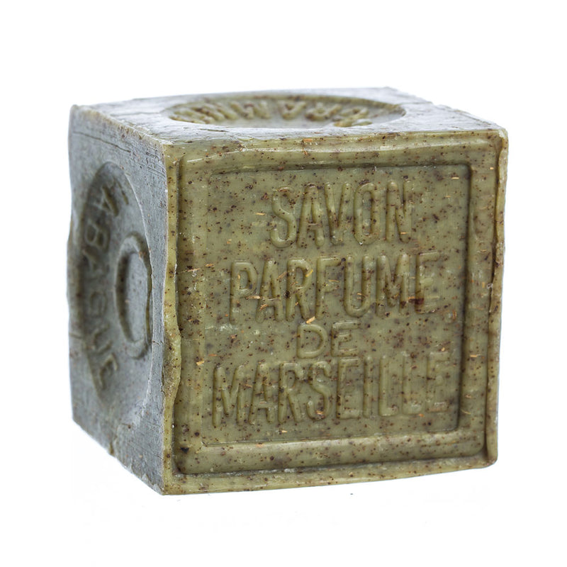 A cube-shaped, natural beige French Soaps Savon de Marseille with Crushed Flowers - Verbena soap, isolated on a white background.