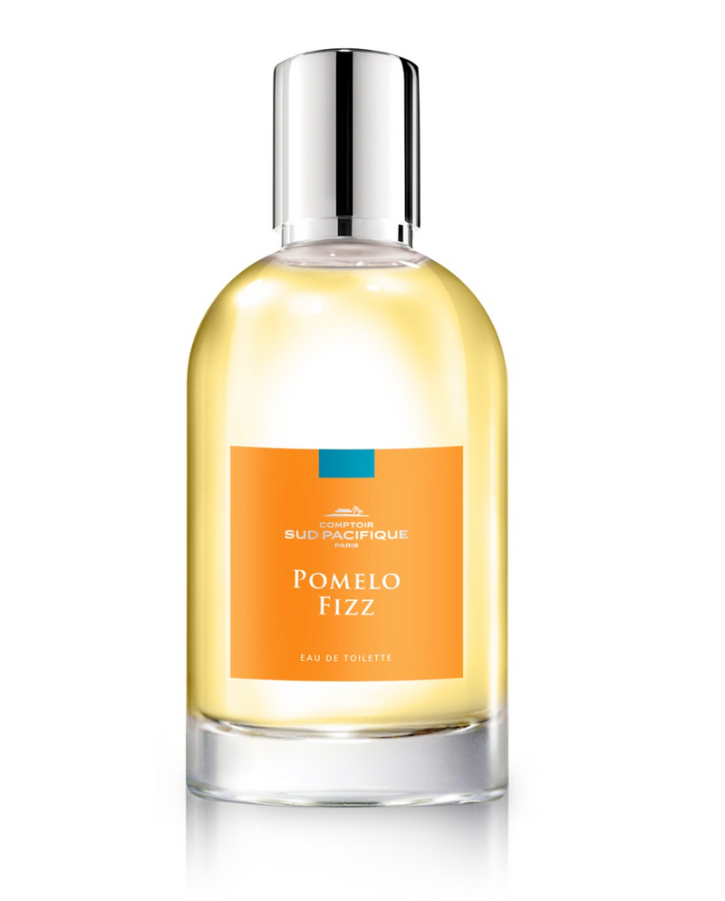 A sleek perfume bottle labeled "Comptoir Sud Pacifique Paris Pomelo Fizz EDT" with a silver cap, featuring a yellow liquid and an orange blossom label set against a white background.