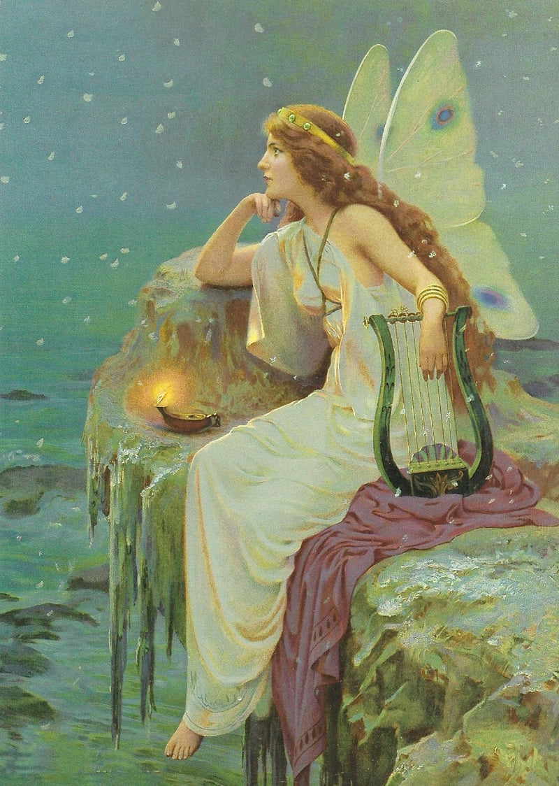 An illustrated painting of an All Occasion Greeting Card - Fairie with Harp by Greeting Cards seated on a rock by the sea, holding a small harp, with large translucent wings and dressed in a flowing white gown, surrounded by a serene blue-green seas.