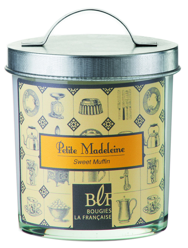 A decorative candle tin with a handle, labeled "Bougies la Francaise Sweet Muffin Candle" by "Bougies la Francaise," featuring a vintage yellow and cream background pattern with various kitchen utensil illustrations.