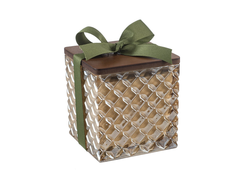 An elegant gift box with a Sonoma Timber Lake Soy Candle in Amber Glass, featuring a reflective gold surface and topped with a dark brown lid and a green bow from Sonoma Lavender.