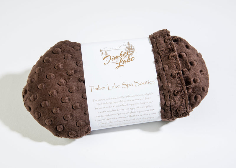 A pair of Sonoma Lavender Timber Lake Sedona Brown Dot Spa Booties displayed on a white background, featuring an attached descriptive tag.