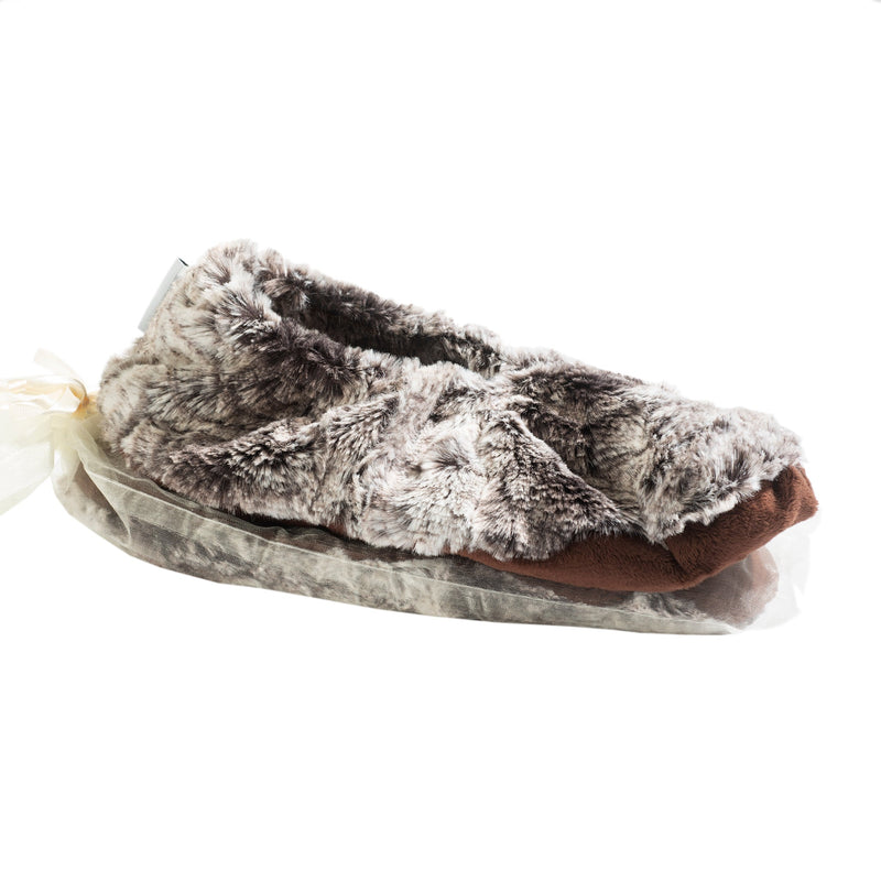 A plush, furry slipper in shades of gray and brown, designed for tired feet, presented in a sheer, light beige drawstring gift bag against a white background.

Replace with:
Sonoma Lavender Timber Lake Winter Frost Heated Footies