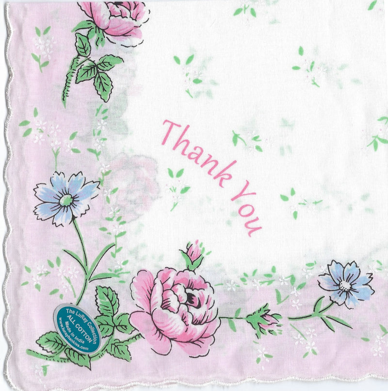 A Vintage-Inspired Hanky - Thank You Hanky from Hankies ala Carte, a square fabric, 100% pure cotton, with a floral design and the words "thank you" in cursive, surrounded by pink and blue flowers, and a seal that reads "the best".