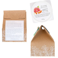 Packaging for The Cottage Greenhouse Grapefruit & Blood Orange Fine Salt Scrub with apricot kernel oil by Margot Elena. Features a kraft paper box with white floral patterns and a product label detailing ingredients and benefits.