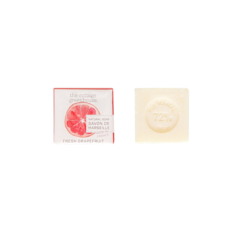 A red box labeled "Margot Elena" featuring 'The Cottage Greenhouse Fresh Grapefruit Soap' next to a beige, triple milled soap bar marked "72% vegetable" against a clean, white background.