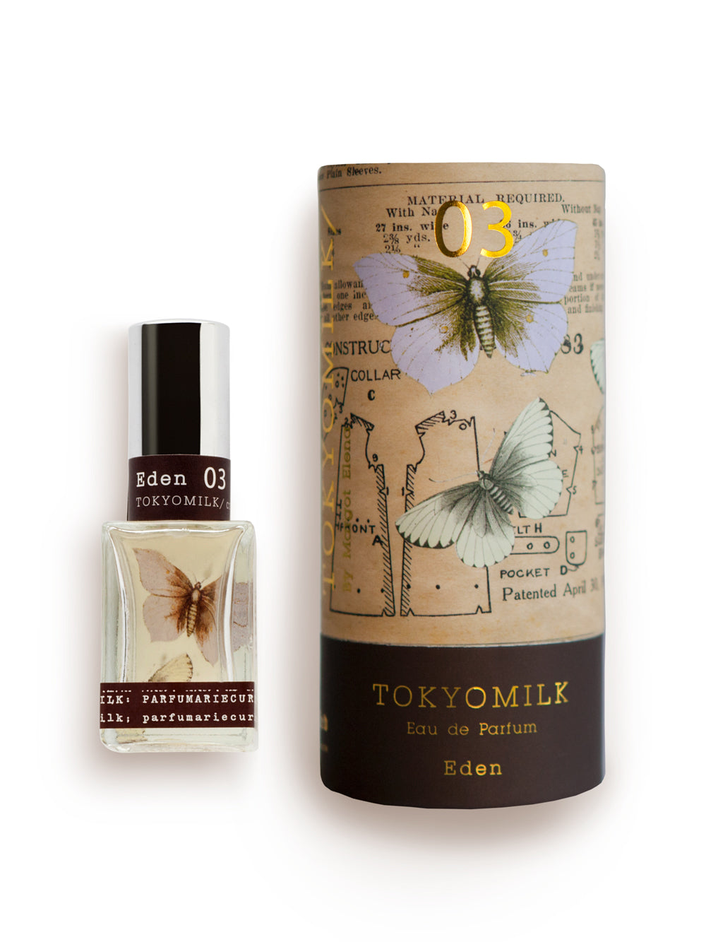 A bottle of Margot Elena's TokyoMilk Eden No. 3 Parfum next to its cylindrical packaging, which is adorned with vintage-inspired graphics featuring insects and old text. Its scent is characterized by notes of White Iris, bronzed