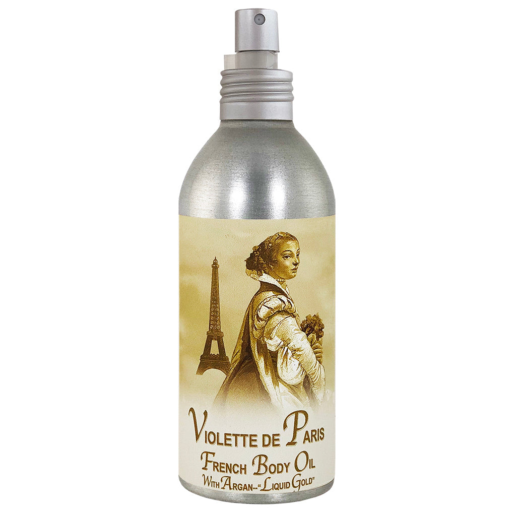 Silver spray bottle of La Bouquetiere Violette de Paris Body Oil featuring a vintage illustration of a woman looking over her shoulder, with the Eiffel Tower in the background.