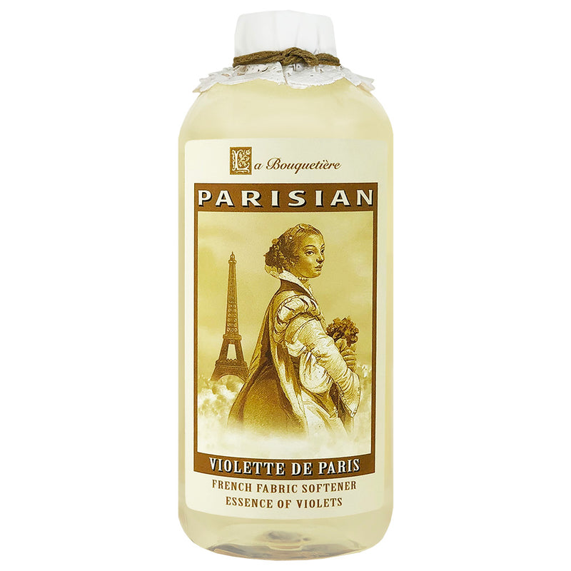 A bottle of "La Bouquetiere Violette de Paris" fabric softener featuring a classic design with an image of a woman holding flowers near the Eiffel Tower. The label is in beige.