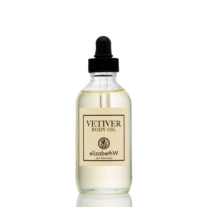 Clear glass bottle of elizabeth W Signature Vetiver Body Oil with a black dropper, labeled "elizabeth W," against a white background.
